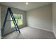 This bedroom offers plush carpeting and a large window with natural light at 147 Tuskeegee Dr, Smithfield, NC 27577