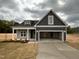 Charming gray home with a two-car garage and inviting front yard at 147 Tuskeegee Dr, Smithfield, NC 27577