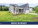 Charming gray home with a well-manicured lawn and inviting front porch at 147 Tuskeegee Dr, Smithfield, NC 27577