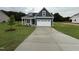 Charming home with a well-manicured lawn and a spacious two-car garage at 147 Tuskeegee Dr, Smithfield, NC 27577