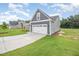 Spacious two-car garage with a gray exterior and long driveway at 147 Tuskeegee Dr, Smithfield, NC 27577