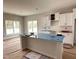 Bright kitchen with white cabinets, a large island, and stainless steel appliances at 147 Tuskeegee Dr, Smithfield, NC 27577
