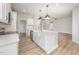 New kitchen showcasing a large island with a farmhouse sink, stainless steel dishwasher, and white cabinetry at 147 Tuskeegee Dr, Smithfield, NC 27577