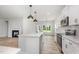 Open kitchen with an island, stainless steel appliances, and view of the backyard and fireplace at 147 Tuskeegee Dr, Smithfield, NC 27577