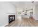 Cozy living room with a fireplace, open to the modern kitchen and dining area at 147 Tuskeegee Dr, Smithfield, NC 27577