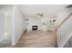 Open-concept living room featuring a fireplace, modern lighting, and wood floors at 147 Tuskeegee Dr, Smithfield, NC 27577