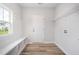 Mudroom featuring a window, bench, storage cubbies, coat hooks, and laundry hookups at 147 Tuskeegee Dr, Smithfield, NC 27577