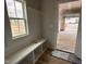Well-lit mudroom with a bench, cubbies, and easy access to the garage at 147 Tuskeegee Dr, Smithfield, NC 27577