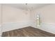 Bright dining room featuring classic wainscoting, modern light fixture, and sleek floors that create an elegant space at 15 Lupin Dr, Smithfield, NC 27577