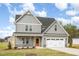 Charming home with gray siding, a two-car garage, and a manicured lawn creates a welcoming curb appeal at 15 Lupin Dr, Smithfield, NC 27577