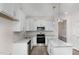 Well-lit kitchen features stainless appliances, light granite countertops, and white cabinets at 15 Lupin Dr, Smithfield, NC 27577