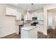 Modern kitchen with white cabinets, granite countertops, stainless steel appliances, and a functional center island at 15 Lupin Dr, Smithfield, NC 27577