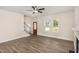 Open living room featuring sleek flooring, staircase with rod iron spindles, and natural light from large windows at 15 Lupin Dr, Smithfield, NC 27577