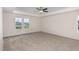 Bright main bedroom with tray ceiling, ceiling fan, and large windows at 15 Lupin Dr, Smithfield, NC 27577