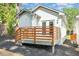 View of home's back exterior with a deck leading to the yard space at 15 St Augustine, Raleigh, NC 27610