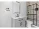 Modern bathroom features vanity sink with tiled shower with glass enclosure at 15 St Augustine, Raleigh, NC 27610