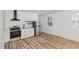 Bright kitchen featuring stainless steel appliances, white cabinetry, and modern black hardware and fixtures at 15 St Augustine, Raleigh, NC 27610