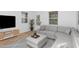 Staged living room filled with warm natural light and modern decor at 15 St Augustine, Raleigh, NC 27610