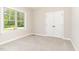Bedroom features large window, carpeted floor, and white door closet at 163 Royal Ave, Selma, NC 27576