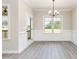 Bright dining room featuring luxury vinyl plank flooring, elegant lighting, and large windows at 163 Royal Ave, Selma, NC 27576