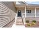 Inviting front porch with brick stairs, white railing, and manicured landscaping at 163 Royal Ave, Selma, NC 27576