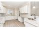 Bright kitchen features white cabinets, granite countertops, and stainless steel sink at 163 Royal Ave, Selma, NC 27576