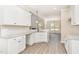 Open kitchen features white cabinets, granite countertops, and stainless steel sink at 163 Royal Ave, Selma, NC 27576