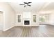 Spacious living room with vaulted ceiling, fireplace, and large windows allowing natural light at 163 Royal Ave, Selma, NC 27576