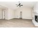 Bright living room with a vaulted ceiling, fireplace, neutral color palette, and luxury vinyl plank flooring at 163 Royal Ave, Selma, NC 27576