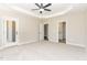 Spacious main bedroom with ceiling fan, carpeted floor, and access to the bathroom at 163 Royal Ave, Selma, NC 27576