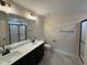 Bathroom featuring double sink vanity, large mirror, shower with glass doors, and modern fixtures at 18 Bonnybrook Ct, Selma, NC 27576