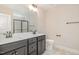 Bathroom featuring a double sink vanity, tile floor, and full mirror at 18 Bonnybrook Ct, Selma, NC 27576