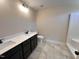 Bathroom with tile flooring, double vanity, and a tub with a shower at 18 Bonnybrook Ct, Selma, NC 27576