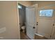 Bathroom with modern fixtures, tile floors, and natural light from the window above the door at 18 Bonnybrook Ct, Selma, NC 27576