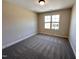 Neutral bedroom with gray carpet, window and a neutral colored walls at 18 Bonnybrook Ct, Selma, NC 27576