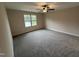 Spacious carpeted bedroom with a ceiling fan and large window offering natural light at 18 Bonnybrook Ct, Selma, NC 27576