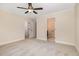 Bedroom showcasing neutral walls and carpet and two open doorways at 18 Bonnybrook Ct, Selma, NC 27576