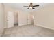 Bedroom showcasing neutral carpet and walls, an open closet and doorway, and a ceiling fan at 18 Bonnybrook Ct, Selma, NC 27576