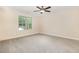 Bright bedroom featuring a ceiling fan, neutral walls and carpet, and a window view at 18 Bonnybrook Ct, Selma, NC 27576