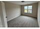 Bedroom with a window letting in natural light and neutral carpet throughout at 18 Bonnybrook Ct, Selma, NC 27576