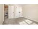 Bedroom showcasing neutral walls and carpet and two open doorways at 18 Bonnybrook Ct, Selma, NC 27576