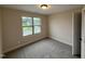 Carpeted bedroom with neutral paint and a window at 18 Bonnybrook Ct, Selma, NC 27576