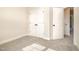 Bright bedroom featuring neutral carpet, light walls, and double-door closet providing ample storage space at 18 Bonnybrook Ct, Selma, NC 27576