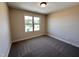 Neutral bedroom with gray carpet, window and a neutral colored walls at 18 Bonnybrook Ct, Selma, NC 27576