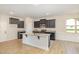 Modern kitchen with dark cabinets, granite countertops, and stainless steel appliances at 18 Bonnybrook Ct, Selma, NC 27576