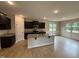 Modern kitchen featuring dark cabinets, granite countertops, stainless steel appliances, and a central island at 18 Bonnybrook Ct, Selma, NC 27576