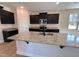 Kitchen island featuring granite countertops, dark cabinets and a stainless steel sink with a modern faucet at 18 Bonnybrook Ct, Selma, NC 27576