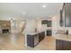 Open-concept kitchen with a granite island, stainless steel appliances, and hardwood floors at 18 Bonnybrook Ct, Selma, NC 27576