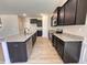 Modern kitchen featuring dark cabinets, granite countertops, stainless steel appliances and a kitchen island at 18 Bonnybrook Ct, Selma, NC 27576