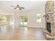 Open-concept living room with a stone fireplace, hardwood floors, and natural light at 18 Bonnybrook Ct, Selma, NC 27576